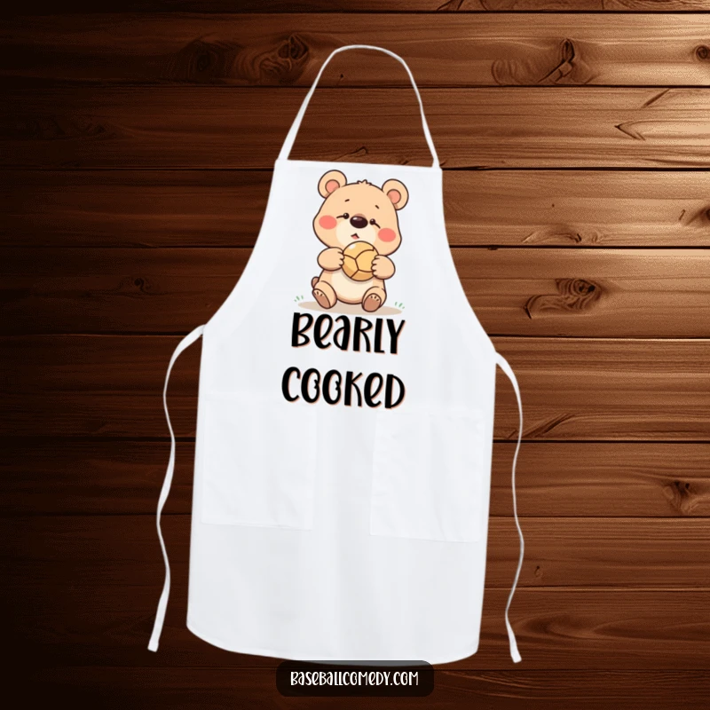 Funny goofy bear missing a baseball catch, ball bouncing off its nose, printed on a practical kitchen apron.