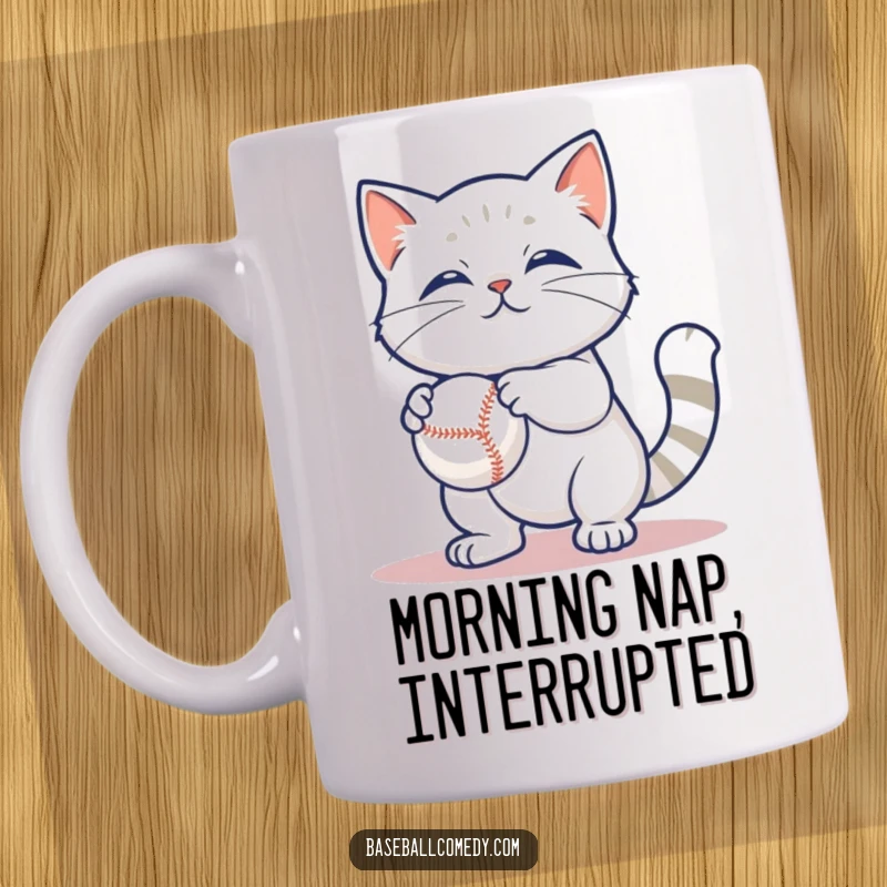 Funny mug with a content cat casually batting at a baseball, depicting playful feline amusement and humor.