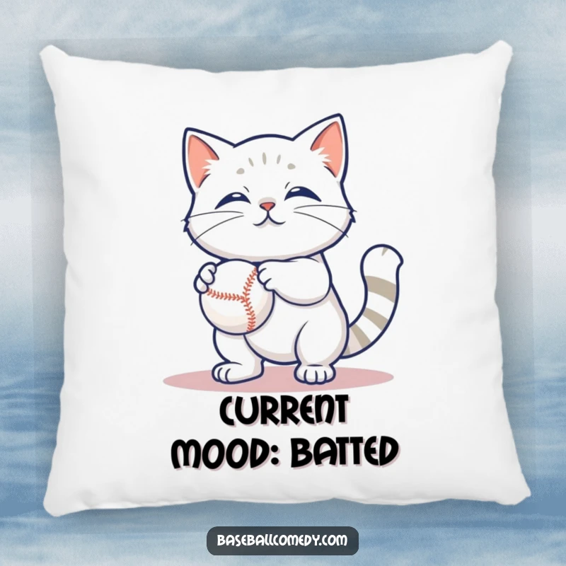 Funny pillow with a content cat batting at a baseball, offering a soft, humorous touch to any room.