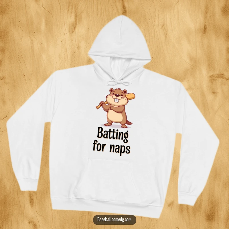 Funny beaver hoodie showing a determined beaver swinging a tiny baseball bat with a hopeful grin, perfect for chilly days.