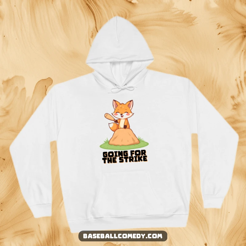 Funny fox hoodie, happily pitching a baseball from a miniature mound, cozy and stylish.