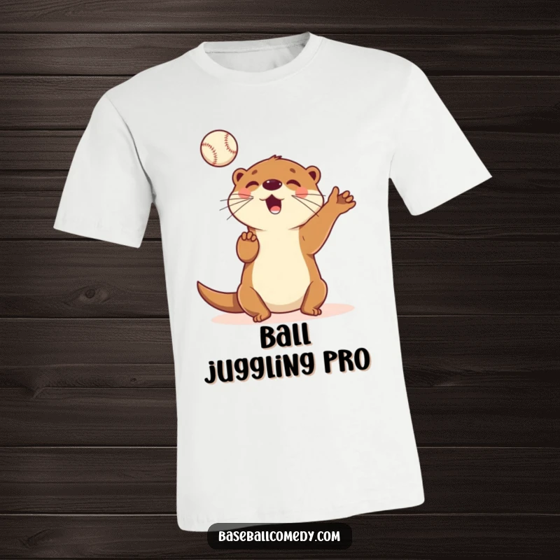 Funny T-shirt depicting a cheerful cartoon otter energetically juggling several baseballs in the air with a playful expression.
