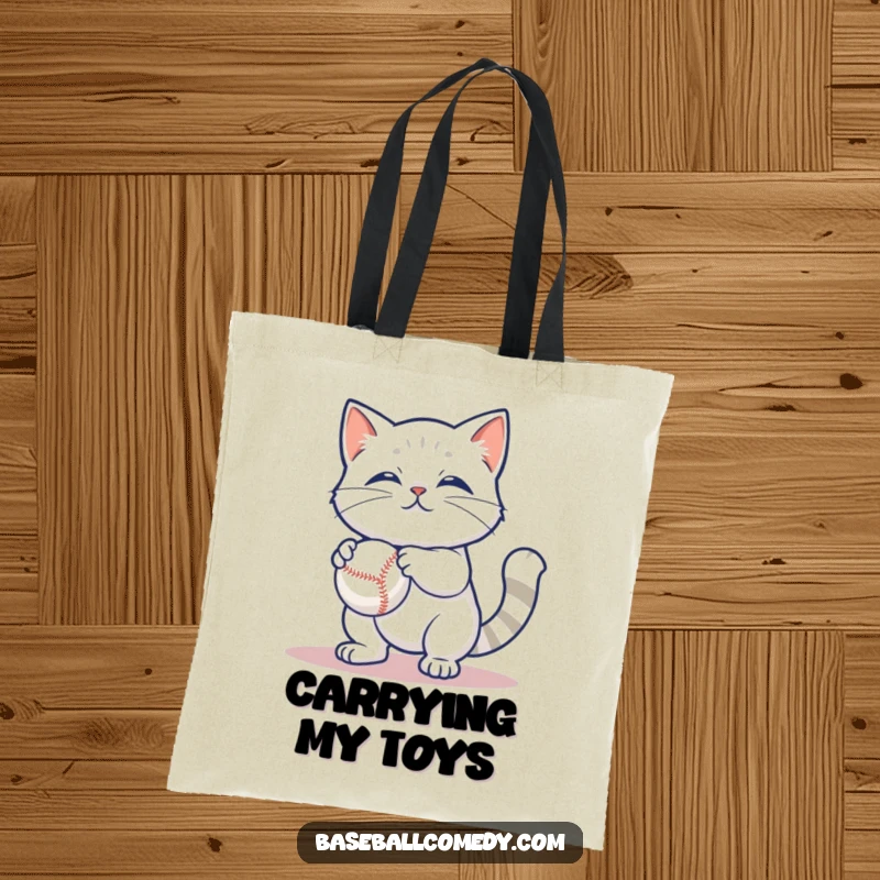 Funny tote bag featuring a content cat batting at a baseball, a practical and humorous accessory for cat lovers.