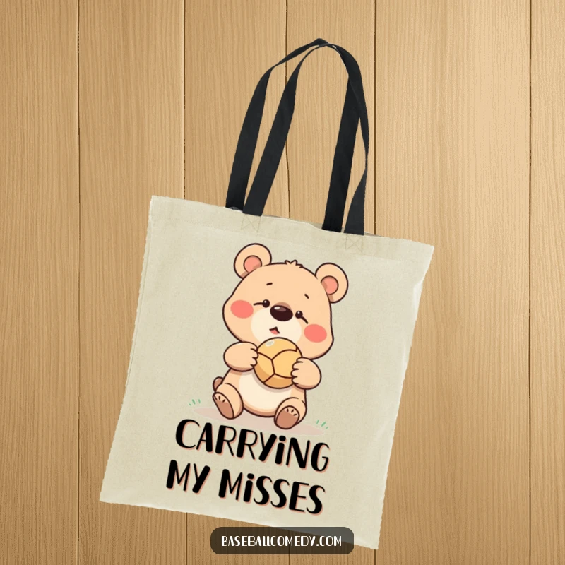 Funny goofy bear missing a baseball catch, ball bouncing off its nose, printed on a durable tote bag.